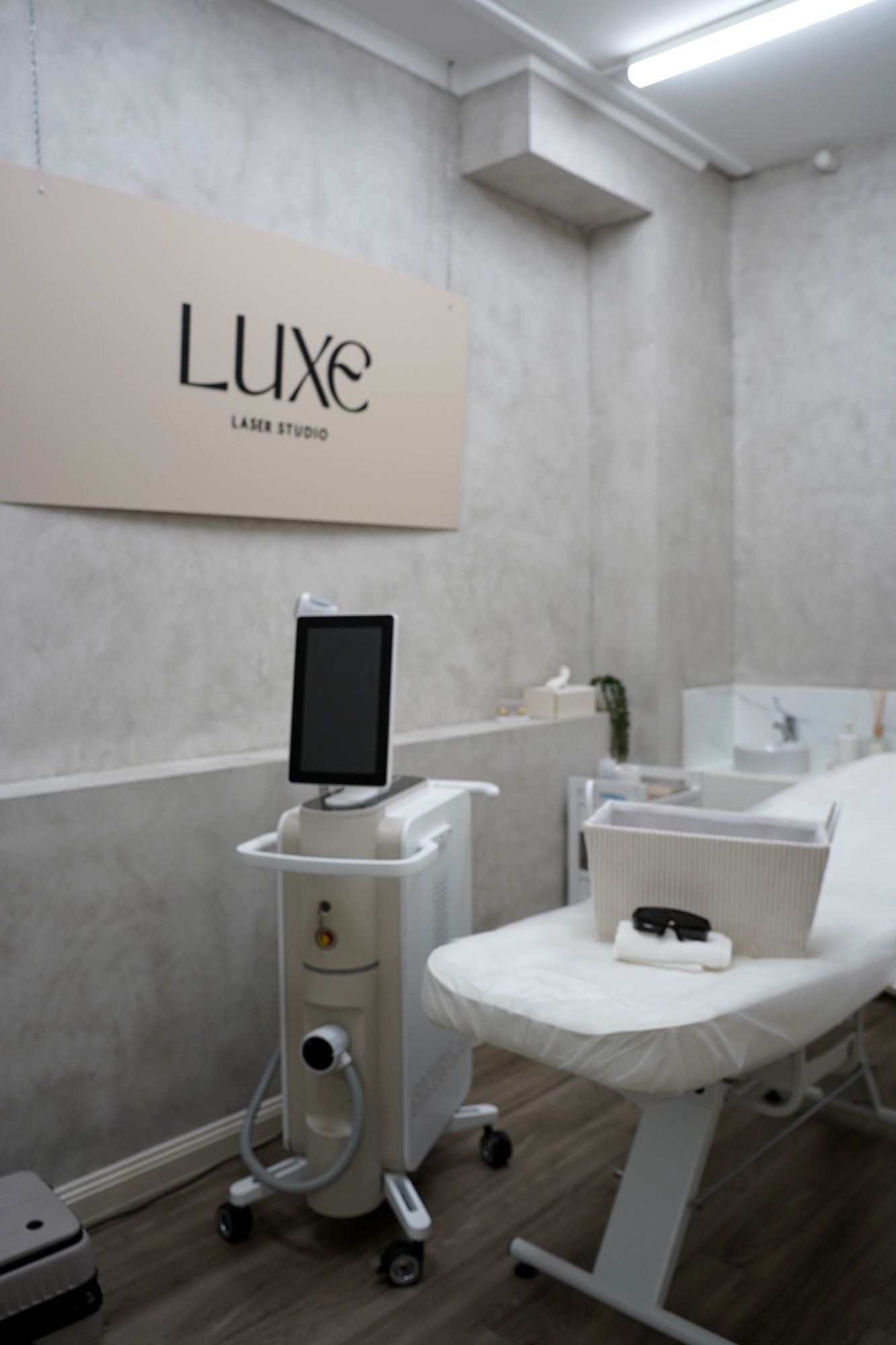 The studio room with the Skyn Lux laser beside the treatment bed