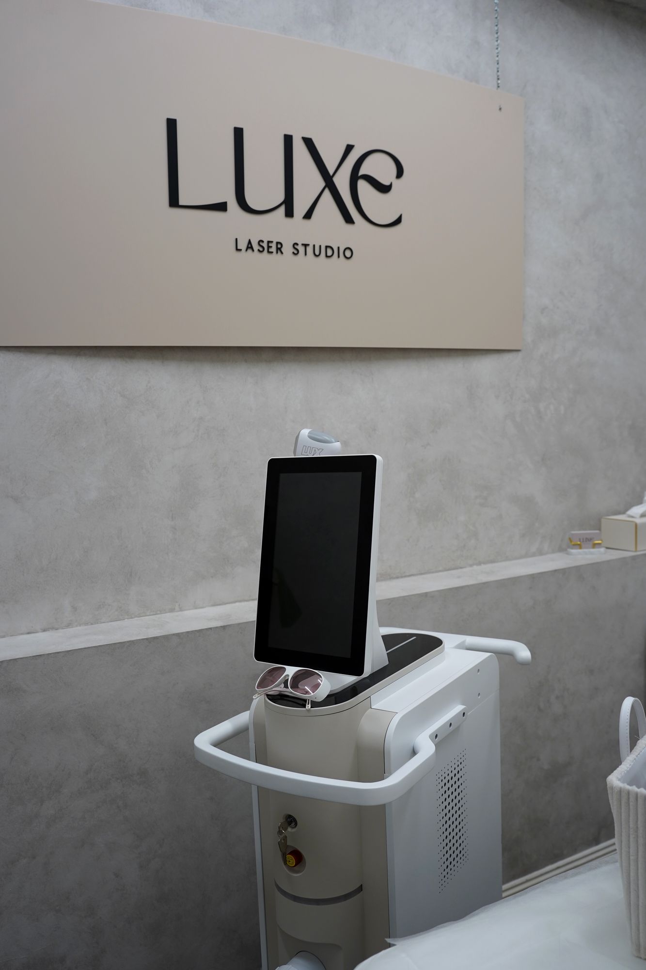 The Skyn Lux laser beneath the Luxe Laser Studio sign
